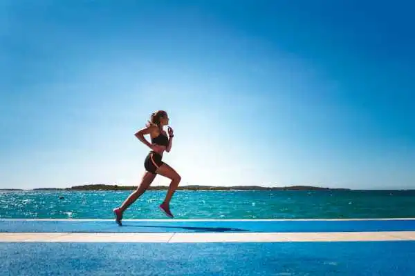 Woman running showing strong leg muscle Gerrards Cross